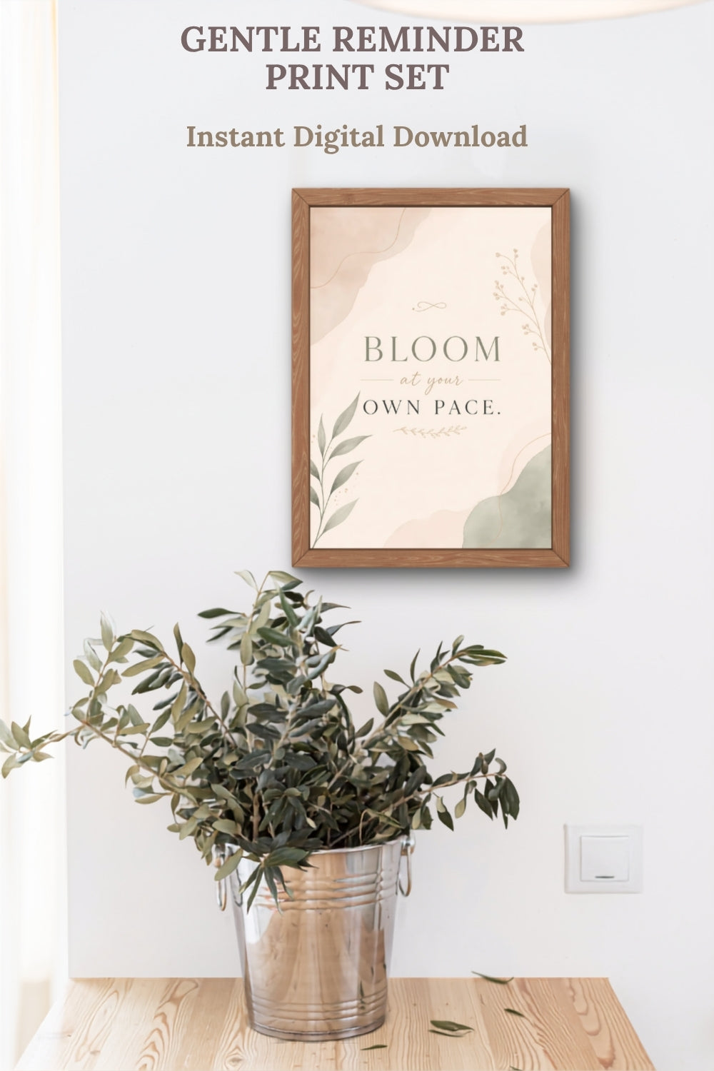 Neutral printable wall art featuring Bloom At Your Own Pace quote print in wooden frame above olive branches styling